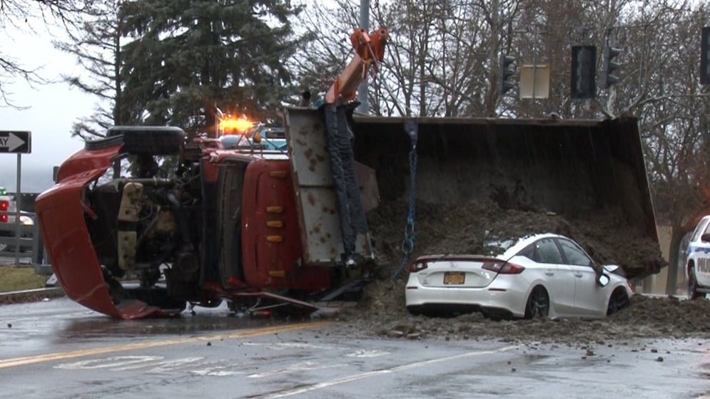 Police: Dump truck overturns, trapping two drivers